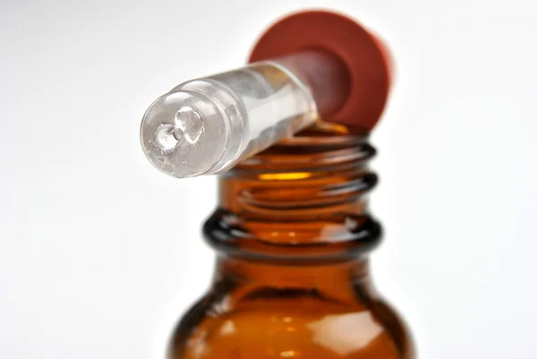 stock image Brown medical bottle and a helpfully pipette