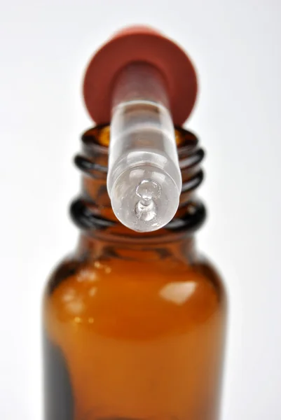 Brown medical bottle and a helpfully pipette — Stock Photo, Image