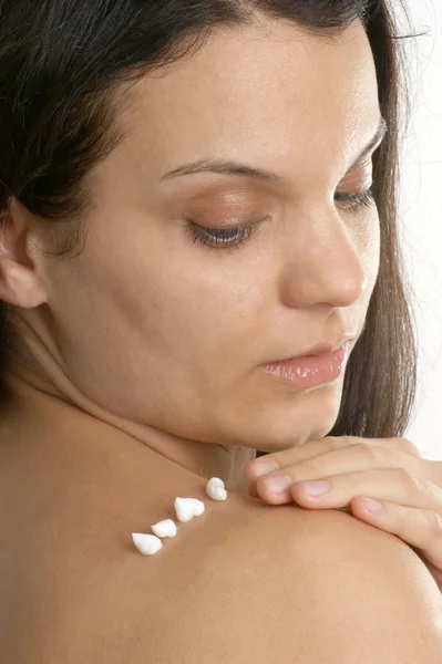 Young woman put on some hydrating cream — Stock Photo, Image
