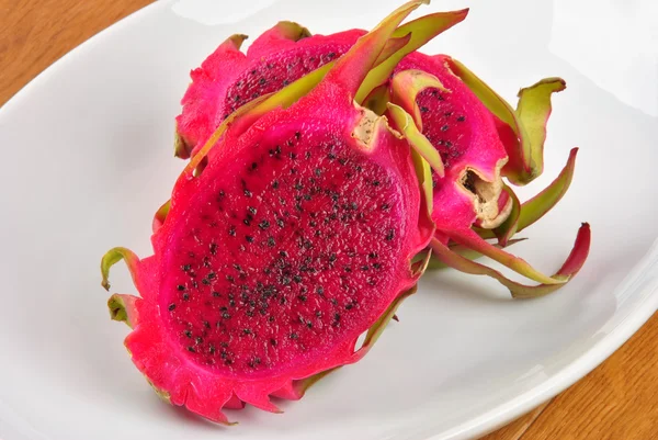 Red organic dragon fruit on a white plate — Stock Photo, Image
