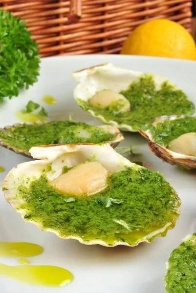 stock image Some organic scallop and herbed butter on a plate