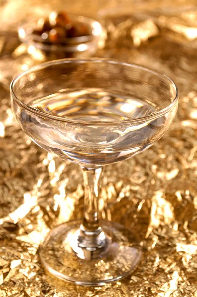 Vodka vermouth cocktail and a golden background — Stock Photo, Image