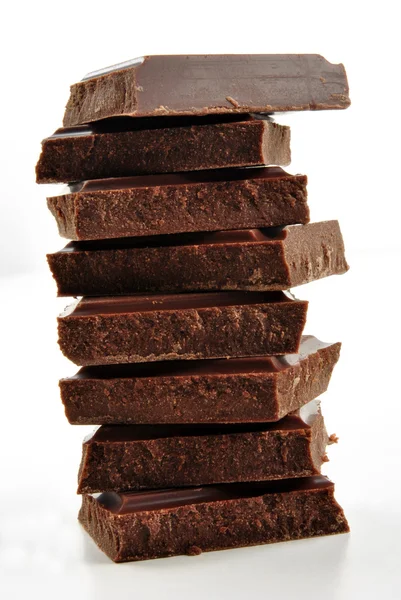 Some stacked chocolate and a white background — Stock Photo, Image