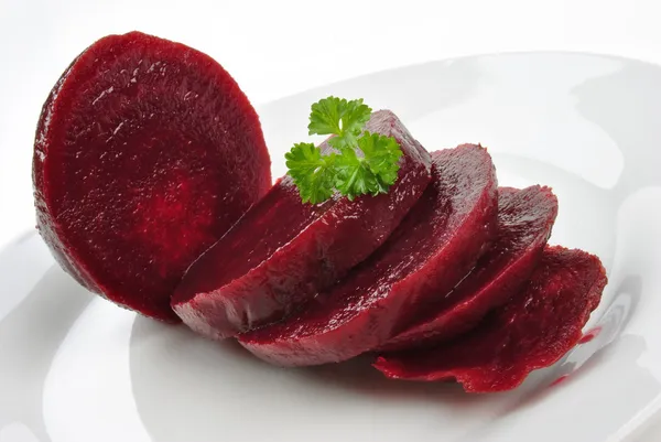 Sliced organic beet root on a white plate — Stock Photo, Image