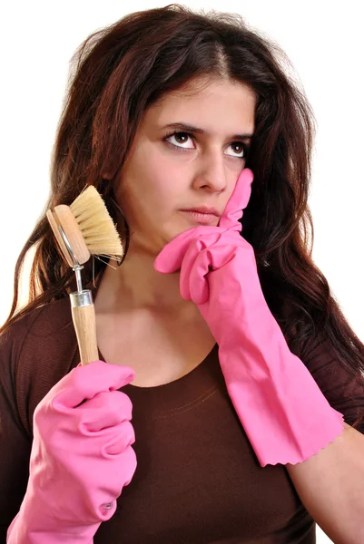 En ung kvinna med en borste och handskar — Stockfoto