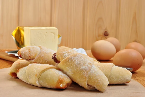 Some home made crescents, magarine and eggs — Stock Photo, Image