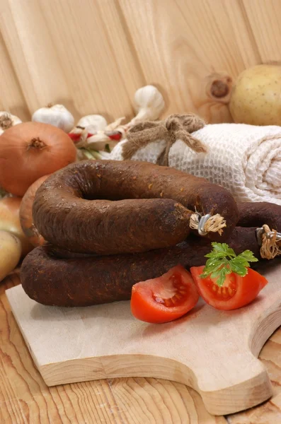 Home made black pudding on a timber board — Stock Photo, Image