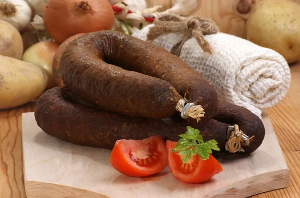 Home made black pudding on a timber board — Stock Photo, Image