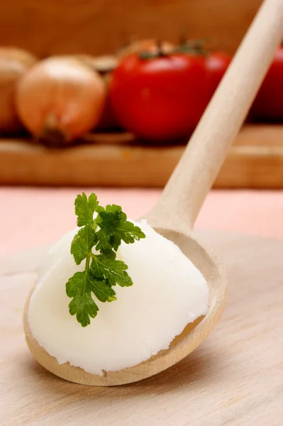 Lard with parsley on a wooden spoon — Stock Photo, Image