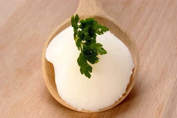 Lard with parsley on a wooden spoon — Stock Photo, Image