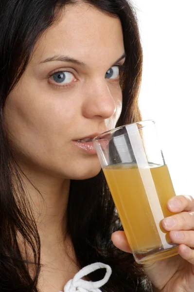 Orange juice is drunk from a glass — Stock Photo, Image
