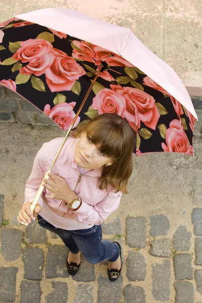 Chica en rosa bajo el paraguas — Foto de Stock