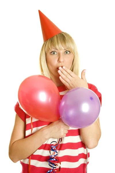 一个美丽的年轻女子在一只手和其他气球中拥有的画像覆盖她的嘴 她的头红纸帽子 表示的惊讶震惊 — 图库照片