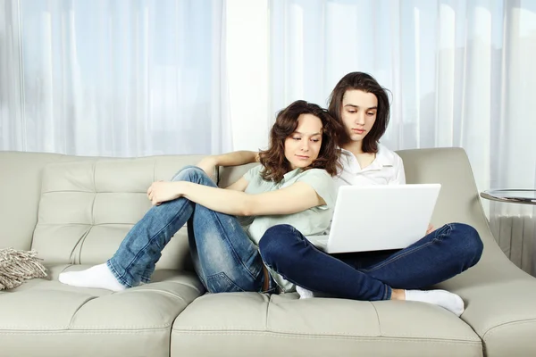 Couple on a couch, browsing — Stock Photo, Image