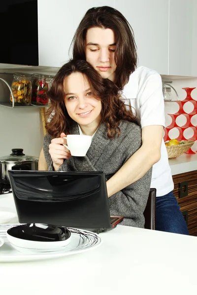 Happy couple in their kitchen Stock Picture