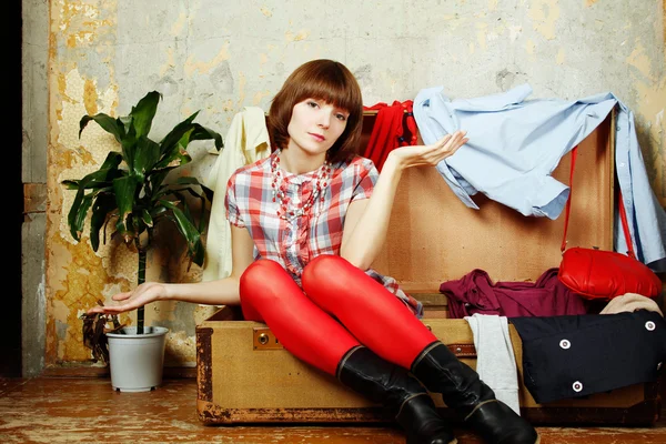 Attractive woman sitting in a suitcase — Stock Photo, Image