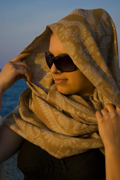 Beautiful woman with scarf on sunset — Stock Photo, Image