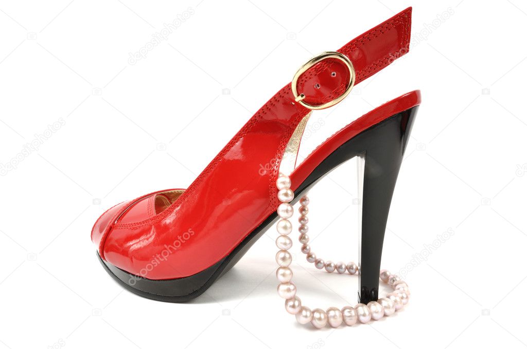 Woman red shoe with pearl necklace on a white background