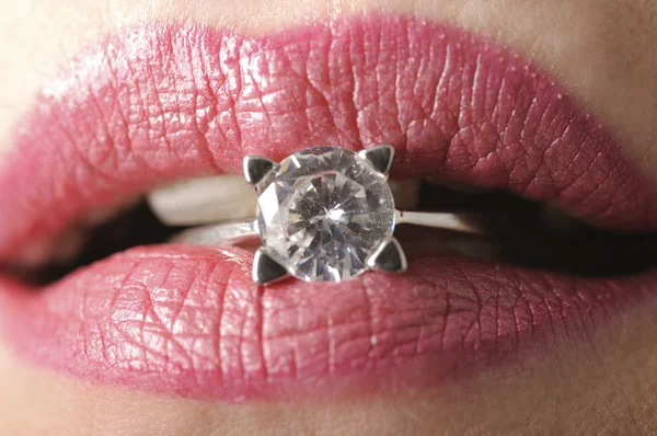 Diamond ring in pink lips — Stock Photo, Image