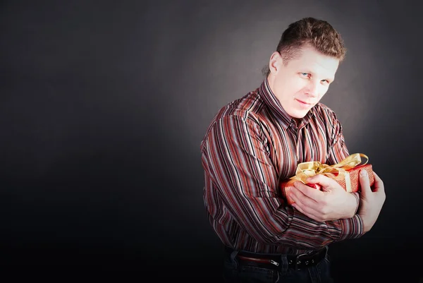 stock image Man pins a gift to itself