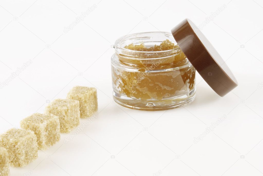 Body Scrub, row of pieces of brown sugar, on a white background