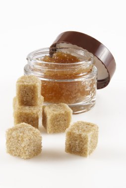 Body scrub with brown sugar crystals clipart