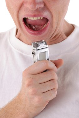 Man open mouth and scream in dictaphone. Close-up clipart