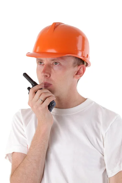 Builder talking on portable UHF radio transceiver isolated — Stock Photo, Image
