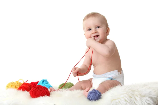Cute little baby playing with balls of wool isolated on white — Stock Photo, Image
