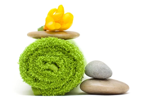Flor amarilla, toalla verde y piedras de río - armonía spa cóncavo —  Fotos de Stock