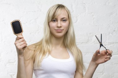Smiling woman hairdresser with professional tools - comb and sci clipart