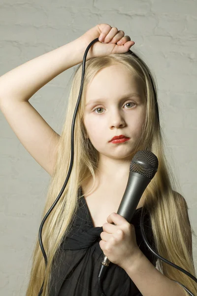 Ładny blond dziewczynka z mikrofonem — Zdjęcie stockowe