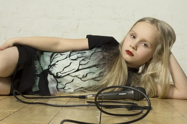 Stock image Young girl with microphone