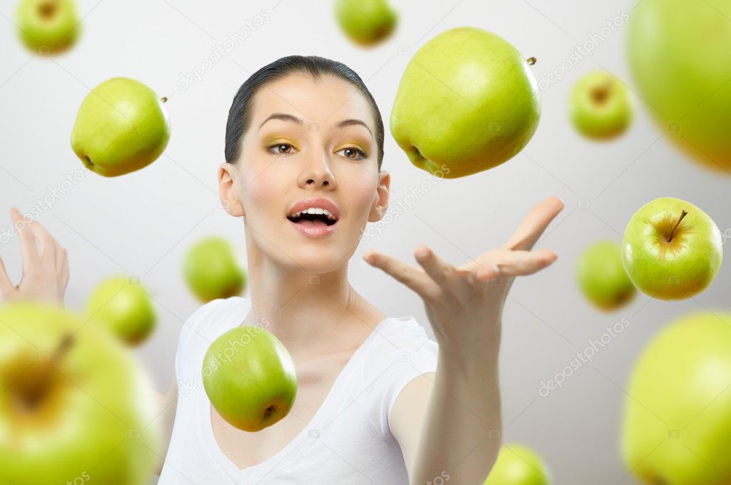 A girl with a ripe green apple