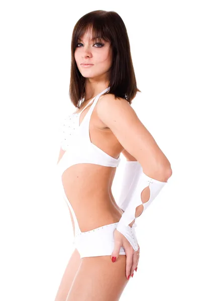 Sexy brunette in white bikini dancing on white background — Stock Photo, Image