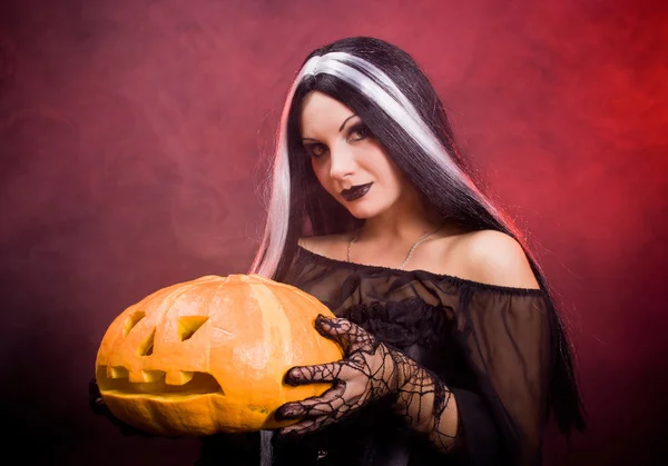 Halloween witch with a pumpkin — Stock Photo, Image