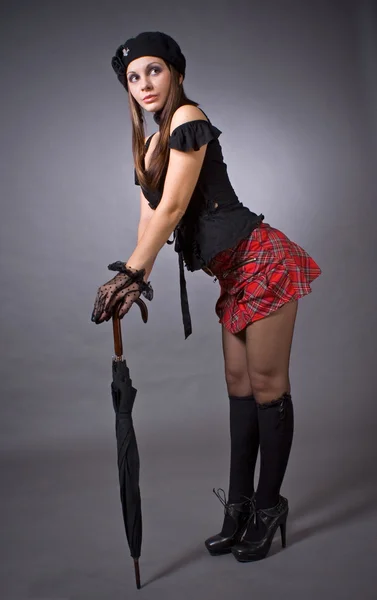 Gothic girl in mini skirt with umbrella — Stock Photo, Image