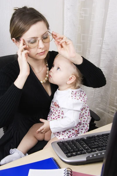 Busy mother with her baby — Stock Photo, Image