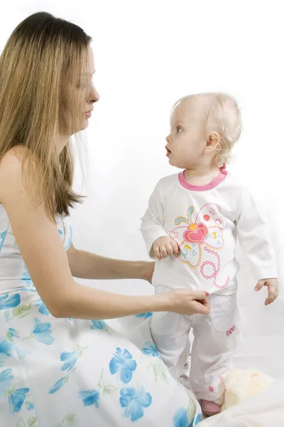 Careful mother dresses the daughter — Stock Photo, Image
