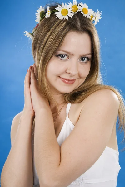 Mulher bonita sorri em um fundo azul — Fotografia de Stock
