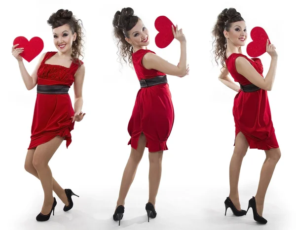 Ženy v červených šatech ukazuje srdce — Stock fotografie