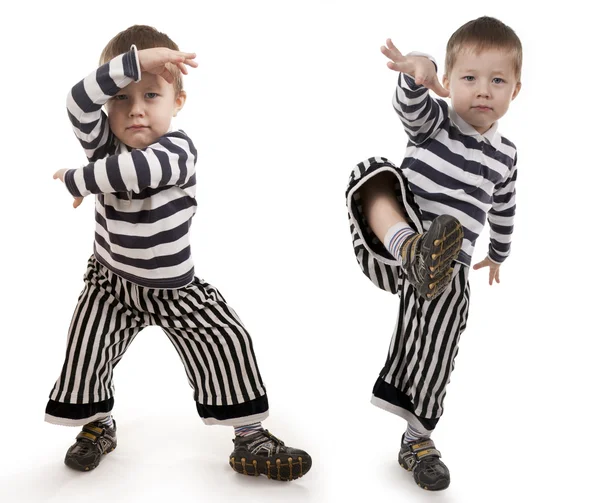 Little boy gesticulates hands and feet — Stock Photo, Image