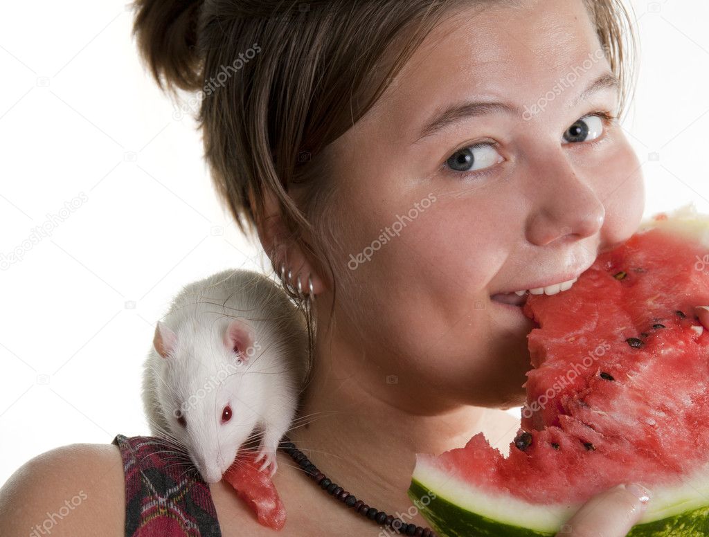 Girl and its pupil (white rat) eats a water-melon