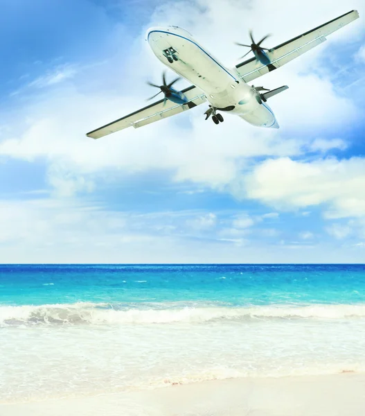 stock image Airplane landing over the tropical lagoon at sunny day