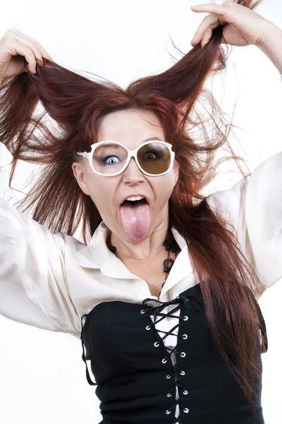 Red-haired woman sticking out her tongue — Stock Photo, Image