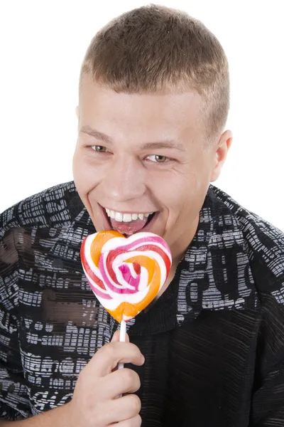 The young man is going to eat a lollypop — Stock Photo, Image