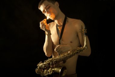 The young jazzman get a light for smoking clipart