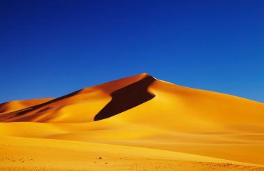 Sand dune in Sahara Desert at sunset, Tadrart, Algeria clipart