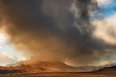 Tibetan landscape with storm clouds clipart