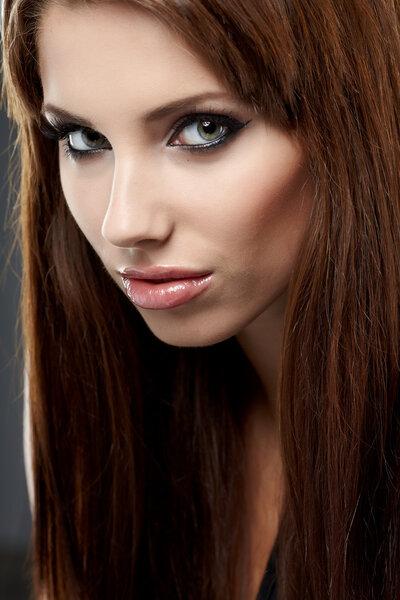 Young brunette woman beauty portrait studio shot